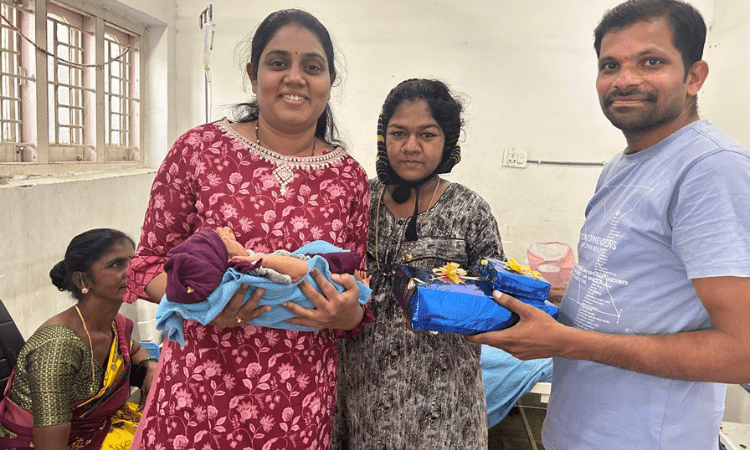 Doctor with a baby and mother after delivery
